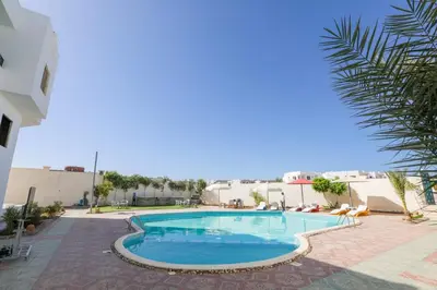 a swimming pool in the middle of a building at La bonita compound for rent in Hurghada