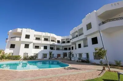 an apartment building with a swimming pool in front of it at La bonita compound for rent in Hurghada