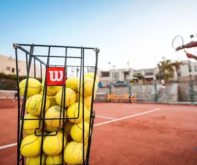a basket full of tennis balls on a tennis court at Azzurra two-bedrooms apartment at Sahl Hasheesh in Hurghada