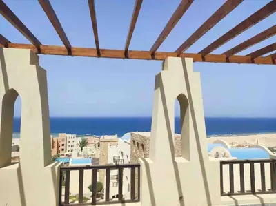 a view of the beach from the balcony of a resort at Azzurra two-bedrooms apartment at Sahl Hasheesh in Hurghada
