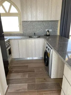 a kitchen with a sink and a washing machine at Azzurra two-bedrooms apartment at Sahl Hasheesh in Hurghada
