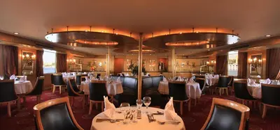 a restaurant with tables and chairs in a room at Iberotel Amara Nile Cruise - Every Thursday from Luxor for 07 & 04 Nights - Every Monday From Aswan for 03 Nights in Luxor