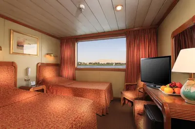a hotel room with a television and a living room at Iberotel Amara Nile Cruise - Every Thursday from Luxor for 07 & 04 Nights - Every Monday From Aswan for 03 Nights in Luxor
