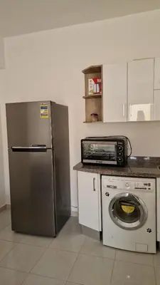 a kitchen with a refrigerator and a washing machine at La bonita one bedroom apartment in Hurghada