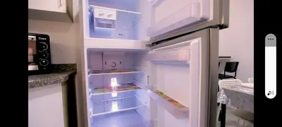an empty refrigerator with its door open in a kitchen at La bonita one bedroom apartment in Hurghada