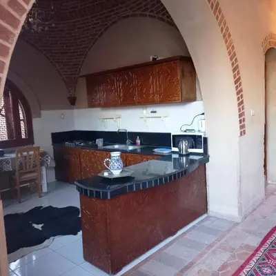 a kitchen with a counter in an arch way at Mystical habou domes villa private pool in Luxor