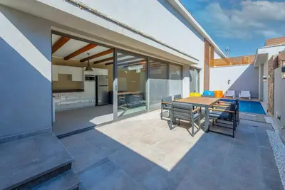 a patio with a table and chairs and a kitchen at Modern & Comfy 2BR in Bali, El Gouna. Private Patio & Pool in Hurghada