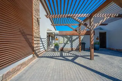 a wooden pergola on the side of a building at Modern & Comfy 2BR in Bali, El Gouna. Private Patio & Pool in Hurghada