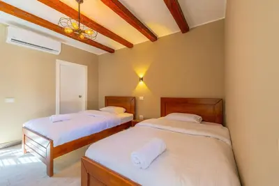 a bedroom with two beds and a ceiling at Modern & Comfy 2BR in Bali, El Gouna. Private Patio & Pool in Hurghada