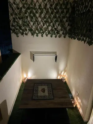 a small room with a wooden table with lights at Benashti Hurghada apartment in Hurghada