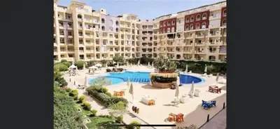 a large apartment building with a large swimming pool at Benashti Hurghada apartment in Hurghada