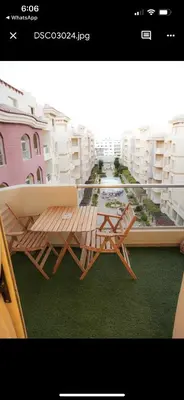 a picture of a balcony with a table and chairs at Benashti Hurghada apartment in Hurghada