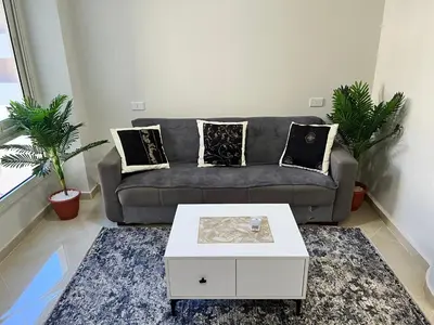 a living room with a couch and a coffee table at Princess Resort (Rayan) in Hurghada