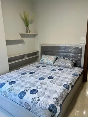 a bed with a blue and white quilt on it at Princess Resort (Rayan) in Hurghada