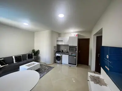 a living room with a couch and a kitchen at Princess Resort (Rayan) in Hurghada