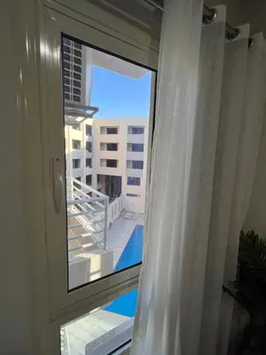 a window with a view of a balcony with a pool at Princess Resort (Rayan) in Hurghada