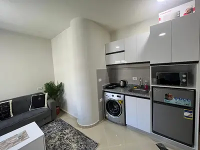 a small kitchen with a washing machine and a washer at Princess Resort (Rayan) in Hurghada