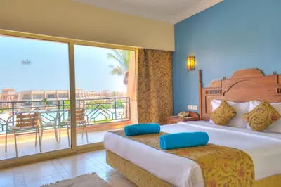 a bedroom with a large bed and a balcony at Jasmine Palace Resort in Hurghada