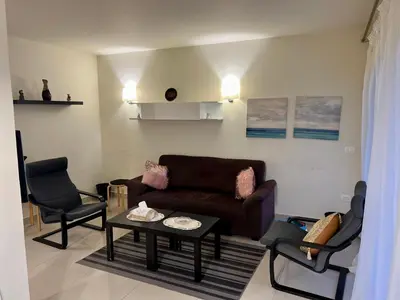 a living room with a couch and a table and chairs at veranda sahl hasheesh in Hurghada