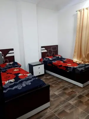 two beds sitting in a room with at Coral House in Hurghada