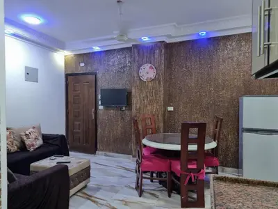 a living room with a table and a couch at Coral House in Hurghada