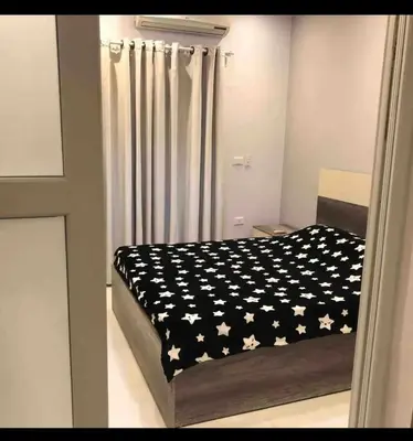 a bedroom with a bed with a black and white comforter at Sea view Apartment in Hurghada