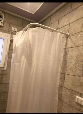 a shower curtain hanging from a rod in a bathroom at Sea view Apartment in Hurghada