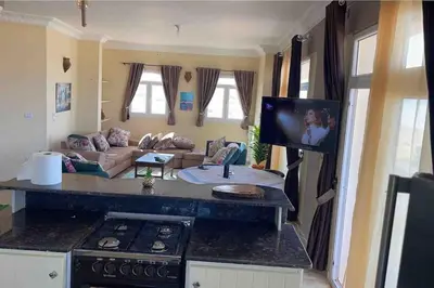a kitchen and living room with a stove and a couch at Sunshine villa ( south Safaga ) in Safaga