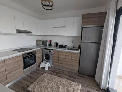 a kitchen with a stainless steel refrigerator and a dishwasher at Somabay Retreat 2BR Apartment in Hurghada