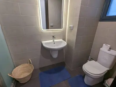 a small bathroom with a toilet and a sink at Somabay Retreat 2BR Apartment in Hurghada
