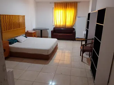 a bedroom with a bed and a yellow curtain at Entertainment Central Location in Hurghada