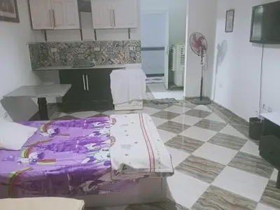 a room with a bed and a tiled floor at Entertainment Central Location in Hurghada