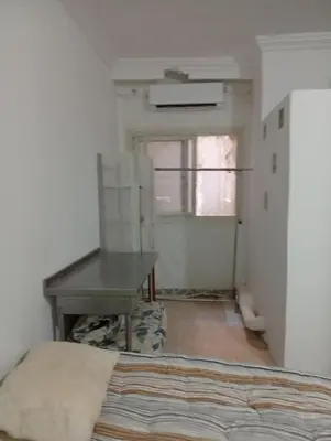 a room with a bed and a table and a window at Entertainment Central Location in Hurghada