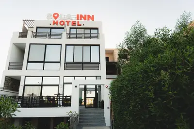 a white building with a hotel sign on it at SOLA INN Hotel Hurghada in Hurghada