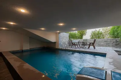 a swimming pool in a house with a table and chairs at SOLA INN Hotel Hurghada in Hurghada