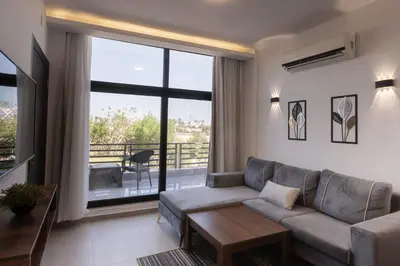 a living room with a couch and a large window at SOLA INN Hotel Hurghada in Hurghada