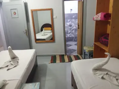 a room with two beds and a mirror at Bob Marley Peace hotel luxor in Luxor