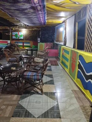 a restaurant with tables and chairs in a room at Bob Marley Peace hotel luxor in Luxor