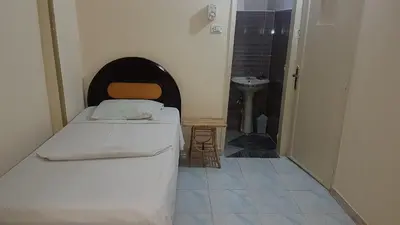 a small bedroom with a bed and a sink at Bob Marley Peace hotel luxor in Luxor