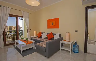 a living room with a couch and a table at Buki-Gravity-Homes, Ap No2, seaview , HEATED pool, 5 star resort Gravity Sahl Hasheesh-FOR GUESTS WITH NONEGYPTIAN PASSPORTS in Hurghada