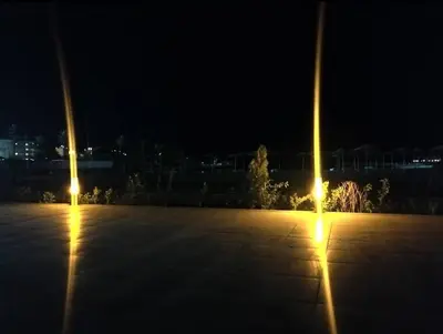 two poles with lights in a parking lot at night at Scandic Resort Hurghada in Hurghada