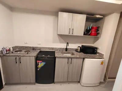 a small kitchen with a sink and a counter at Scandic Resort Hurghada in Hurghada