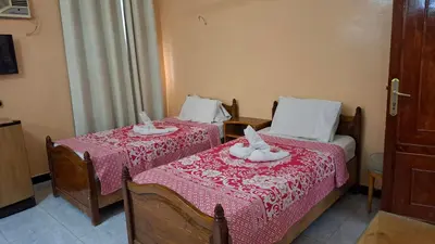 a bedroom with two beds with towels on them at West Bank Guest House in Luxor