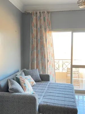 a living room with a couch and a window at Red Ruby Compound منتجع الياقوتة الحمراء in Hurghada
