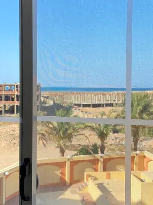 a view of the beach from a window at Red Ruby Compound منتجع الياقوتة الحمراء in Hurghada