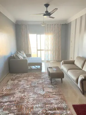 a living room with a couch and a table at Red Ruby Compound منتجع الياقوتة الحمراء in Hurghada