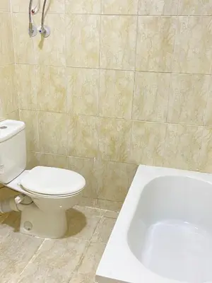 a bathroom with a toilet and a bath tub at Red Ruby Compound منتجع الياقوتة الحمراء in Hurghada