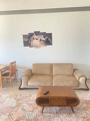 a living room with a couch and a coffee table at Red Ruby Compound منتجع الياقوتة الحمراء in Hurghada