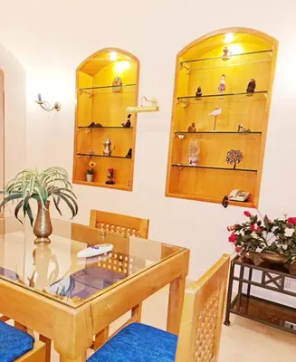 a dining room with a glass table and chairs at West golf 2bedroom in Hurghada