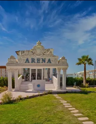 a white entrance to a building with a palm tree at SELENA BAY RESORT WITH PRIVATE BEACH,SEA VIEw in Hurghada
